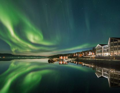 northern norway malangen resort aurora over fjord
